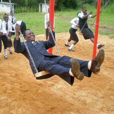 Head Teacher Mr Mwanza enjoying new swing